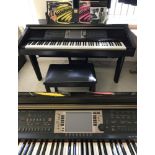A Yamaha Clavinova CVP 207 88 key electronic piano/organ in black wood finish. With piano stool.