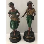 A pair of antique signed painted spelter classic figurines of a bot and girl.