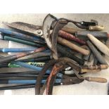 A collection of vintage cutting tools to include loppers, pruners and hand scythes.