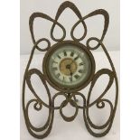 A vintage enamelled face desk clock in ornate metal mount.