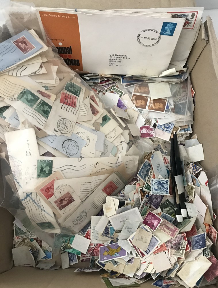 A box of loose British and world stamps.