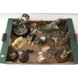 A box of ceramic and resin bird and animal figures.