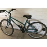 A ladies 5 speed Raleigh mountain bike with green paintwork.