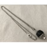 A boxed silver, black onyx and coral Su Coccu pendant and chain.