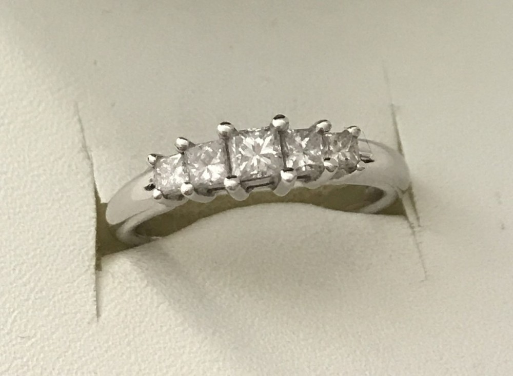 An 18ct white gold 5 stone princess cut diamond eternity ring.