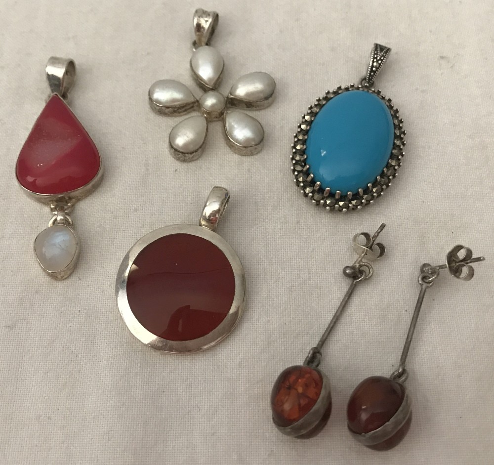 4 natural stone and pearl set silver pendants together with a pair of ball drop amber earrings.