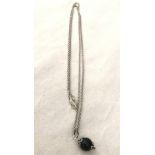 A boxed silver and black onyx Su Coccu pendant and chain.