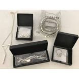 A collection of silver tone Oriflame jewellery with original boxes and packaging.
