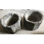 2 octagonal shaped concrete garden planters with decoration to sides.