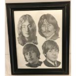 A framed and glazed black and white print of the Beatles.