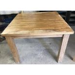 A modern solid oak wood kitchen/dining table.