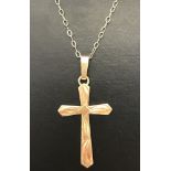 A 9ct gold cross pendant on a 9ct gold very fine belcher chain.