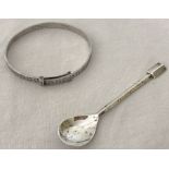 A baby's silver christening bangle, together with a silver mustard spoon.