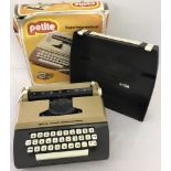 A boxed Petite Super International child's typewriter.