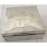 A silver covered square shaped wooden box with engraving to lid.