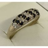 A 9ct gold blue and white sapphire dress ring.