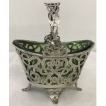 A hallmarked decorative silver bon bon basket on four legs complete with green glass liner.
