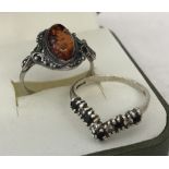 A 925 silver dress ring set with central oval Amber cabochon.