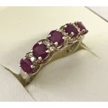 A 925 silver eternity ring set with 5 rubies and 4 small diamonds.