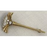 A 18ct gold and diamond brooch in the shape of a stemmed fan.