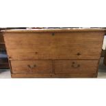 A large antique pine linen chest with 2 lower drawers.