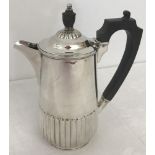 A hallmarked silver lidded water jug with fluted design.