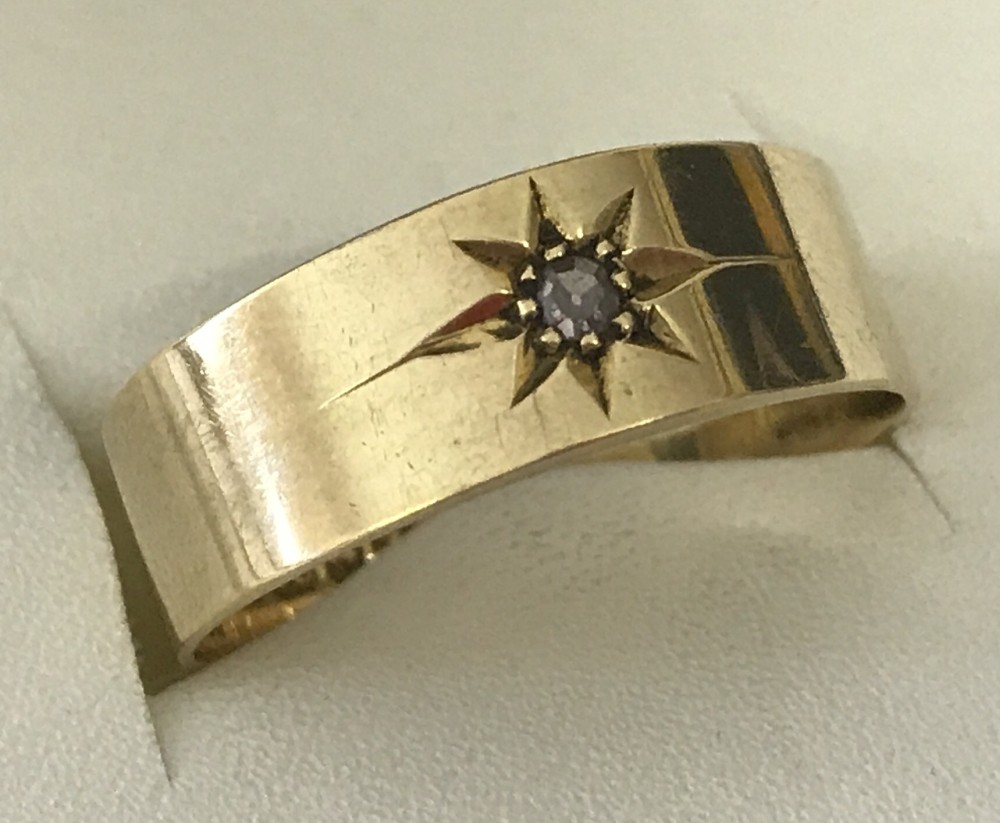 Antique 18ct gold ring with small diamond set into a star mount.