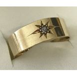 Antique 18ct gold ring with small diamond set into a star mount.