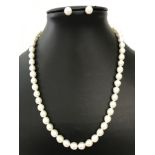 A freshwater pearl necklace and matching earrings.