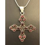 A 925 silver cross set with marquise and round cut garnets. On a 16 inch snake chain.