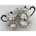 A hallmarked silver Queen Anne style 4 piece tea set with fluted design and pedestal shaped base.
