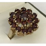 A large 9ct gold garnet set dress ring.