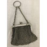 A vintage silver mesh coin purse with finger ring.