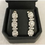 A pair of silver and clear glass drop earrings.