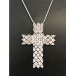 A silver cross pendant set with cubic zirconia stones on a 18inch silver snake chain.