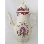 A circa 1790 cream ware coffee pot with purple flower decoration.