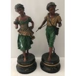 A pair of antique signed painted spelter classic figurines of a boy and girl.