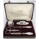 A cased silver manicure set.