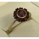 A 9ct gold and garnet dress ring.