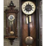 A vintage mahogany cased wall hanging clock complete with pendulum, key and weights.