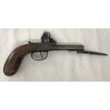 An antique flintlock pistol with flick action short bayonet.