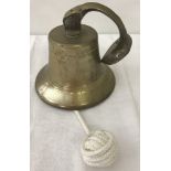 A vintage wall hanging brass bell.