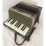 A vintage Ceka - Superior accordion with leather carry strap.