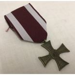WWII pattern Polish Cross of Valour medal on burgundy and white ribbon, dated 1940.