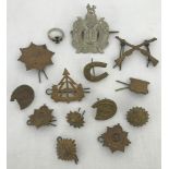 A small collection of military pins and cap badges.