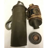 A German WWII pattern gas mask with canister in metal carry case.