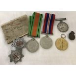 A bag of assorted medals and badges.