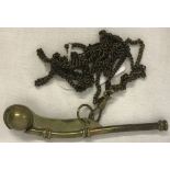 A vintage brass Bosun's whistle on chain.