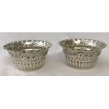 A pair of decorative Victorian silver salts with fluted design to sides and piecrust shaped rims.