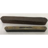 A small vintage wooden and brass spirit level.